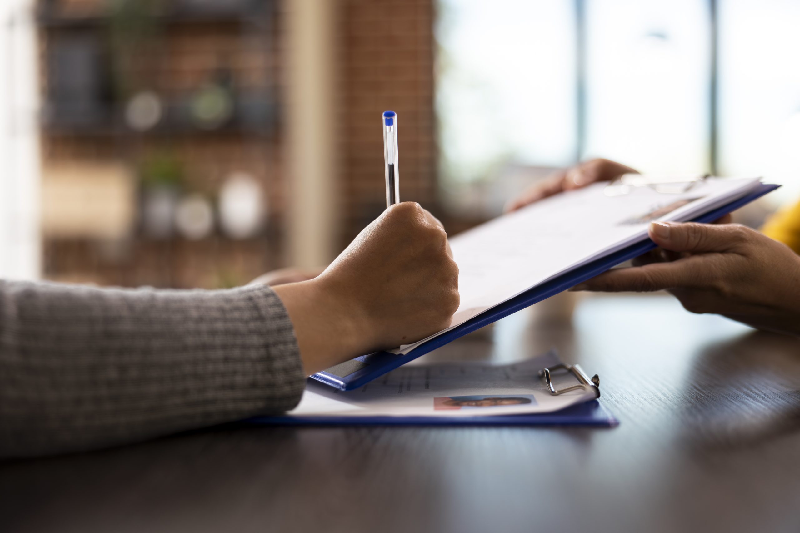Person with pen signing a document